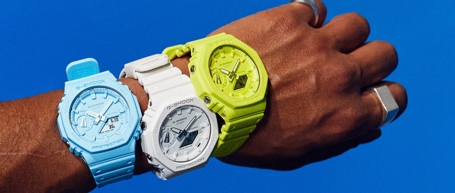 G-SHOCK "Tone on Tone" Modelle GA-2100 in hellblau, weiß und gelb am Handgelenk