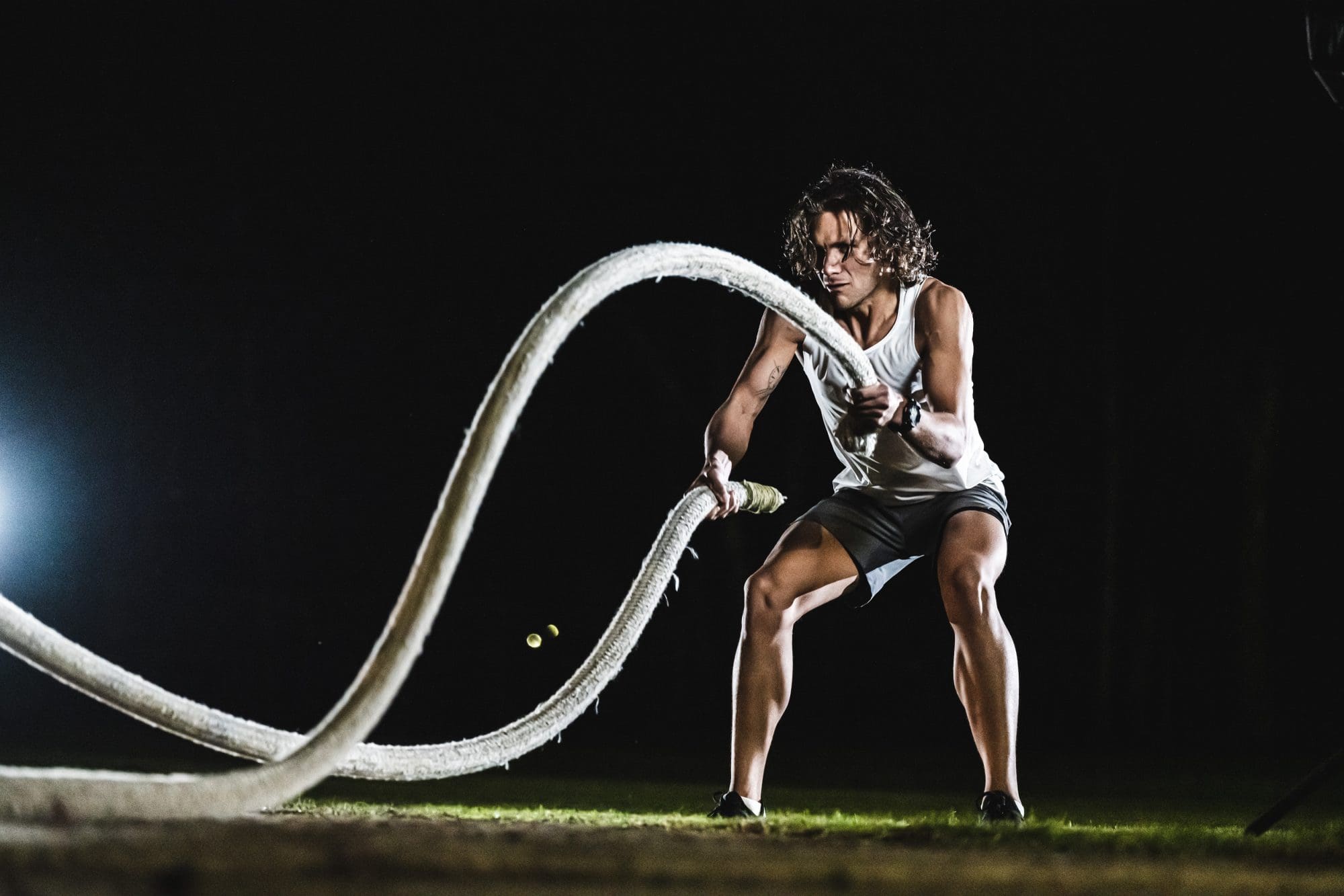 man wearing black G-SHOCK MOVE GBDH2000-1A doing battle ropes exercise man wearing black G-SHOCK MOVE GBDH2000-1A doing battle ropes exercise