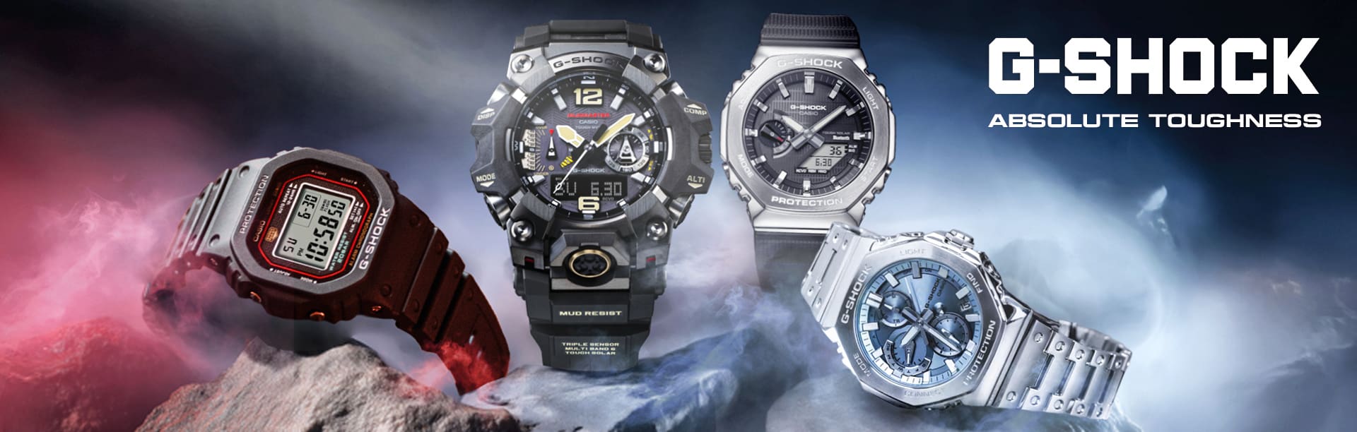 G-SHOCK con fondo azul ahumado y rojo sobre piedras. De izquierda a derecha: DW-5040PG-1 GWG-B1000-1A GBM-2100-1A GMC-B2100AD-2A