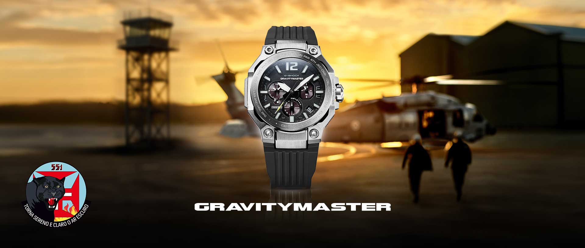 A close-up of the G-SHOCK Gravitymaster (GWR-B3000) with silver case, dark blue dial and strap against a cloudy sky with a blurred jet.