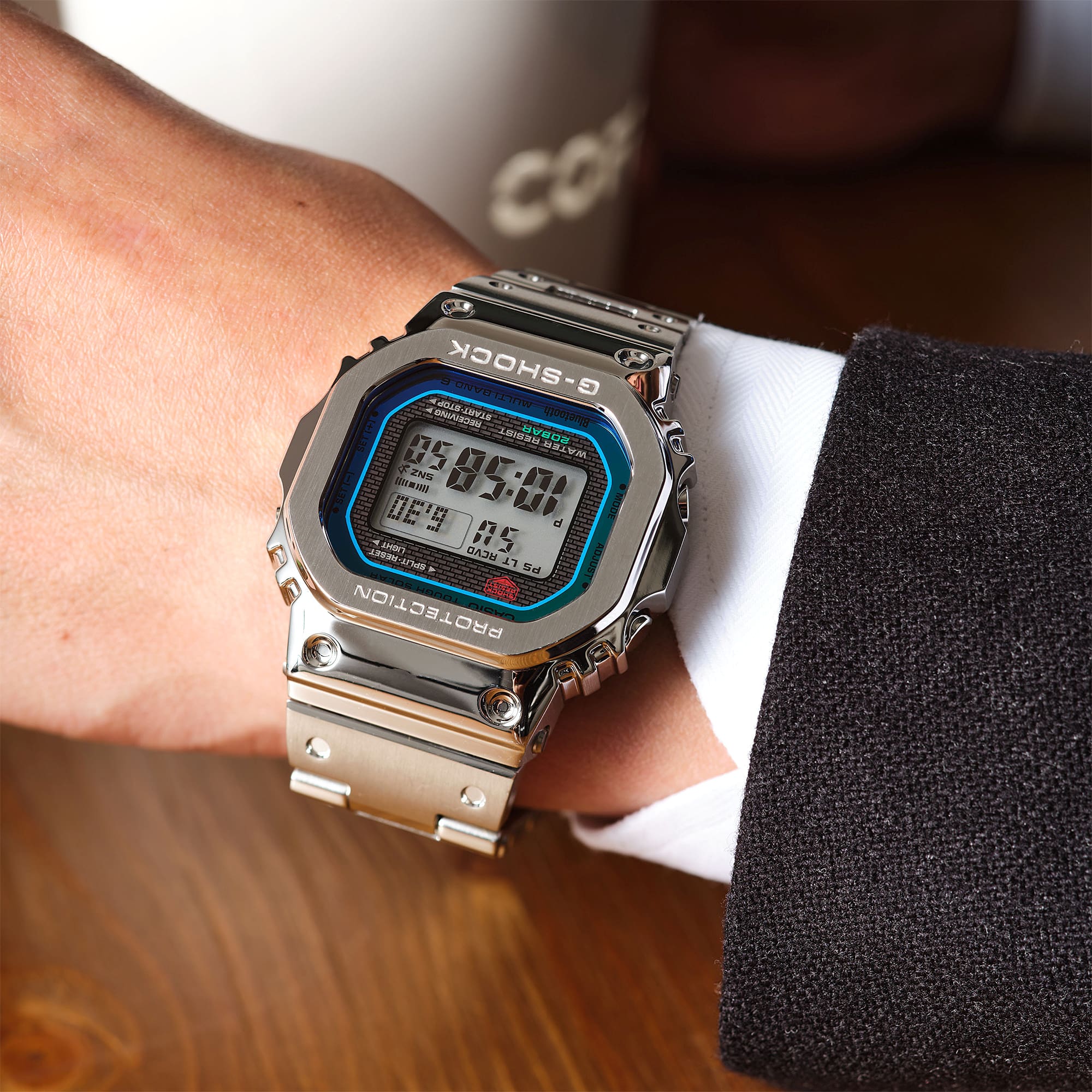 The silver GMW-B5000PC-1 digital watch worn on a man's wrist