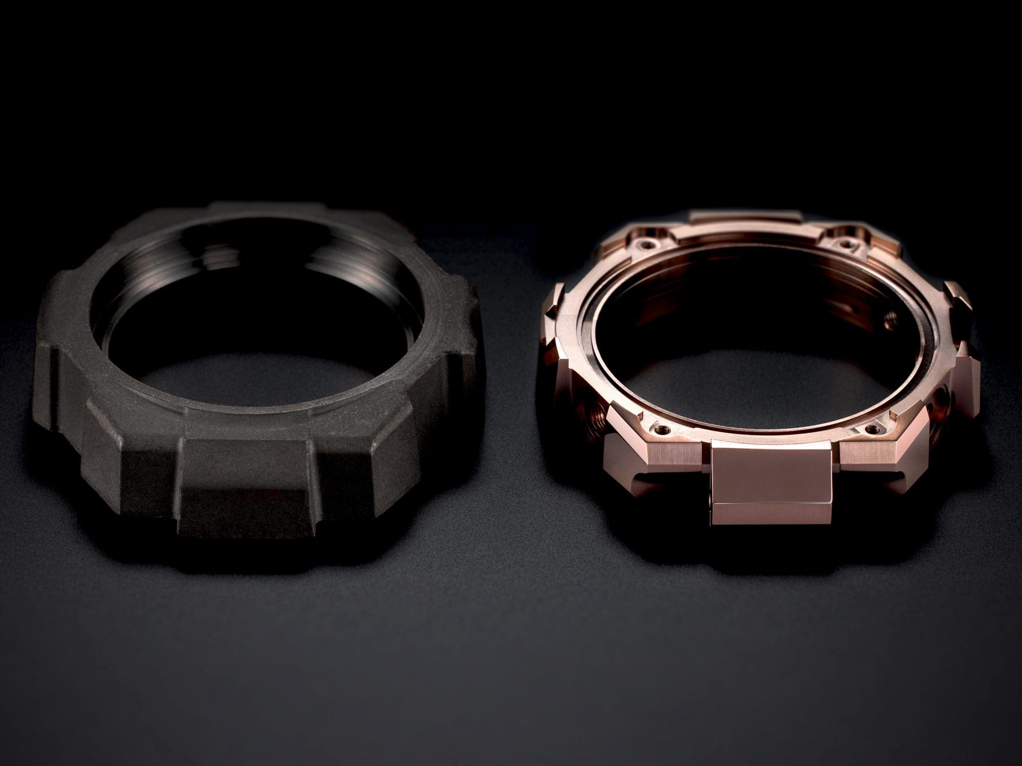 Two case pieces lying next to each other: the one on the left is dark grey, the one on the right is copper-coloured