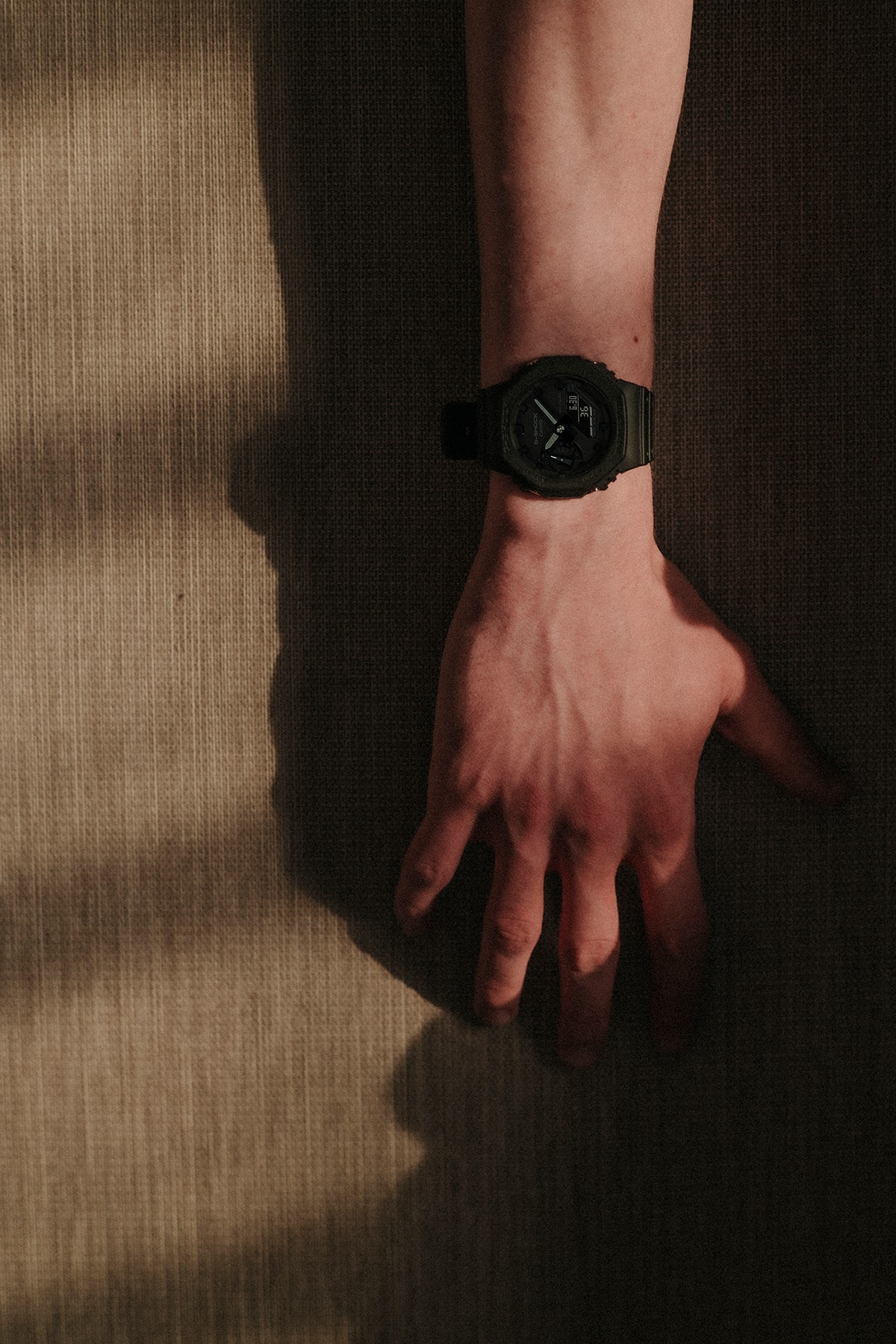A man wearing a G-SHOCK GA-2100 watch on his wrist.