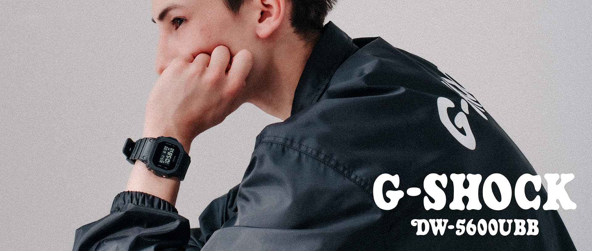 A young man wearing a G-SHOCK DW-5600UBB watch.