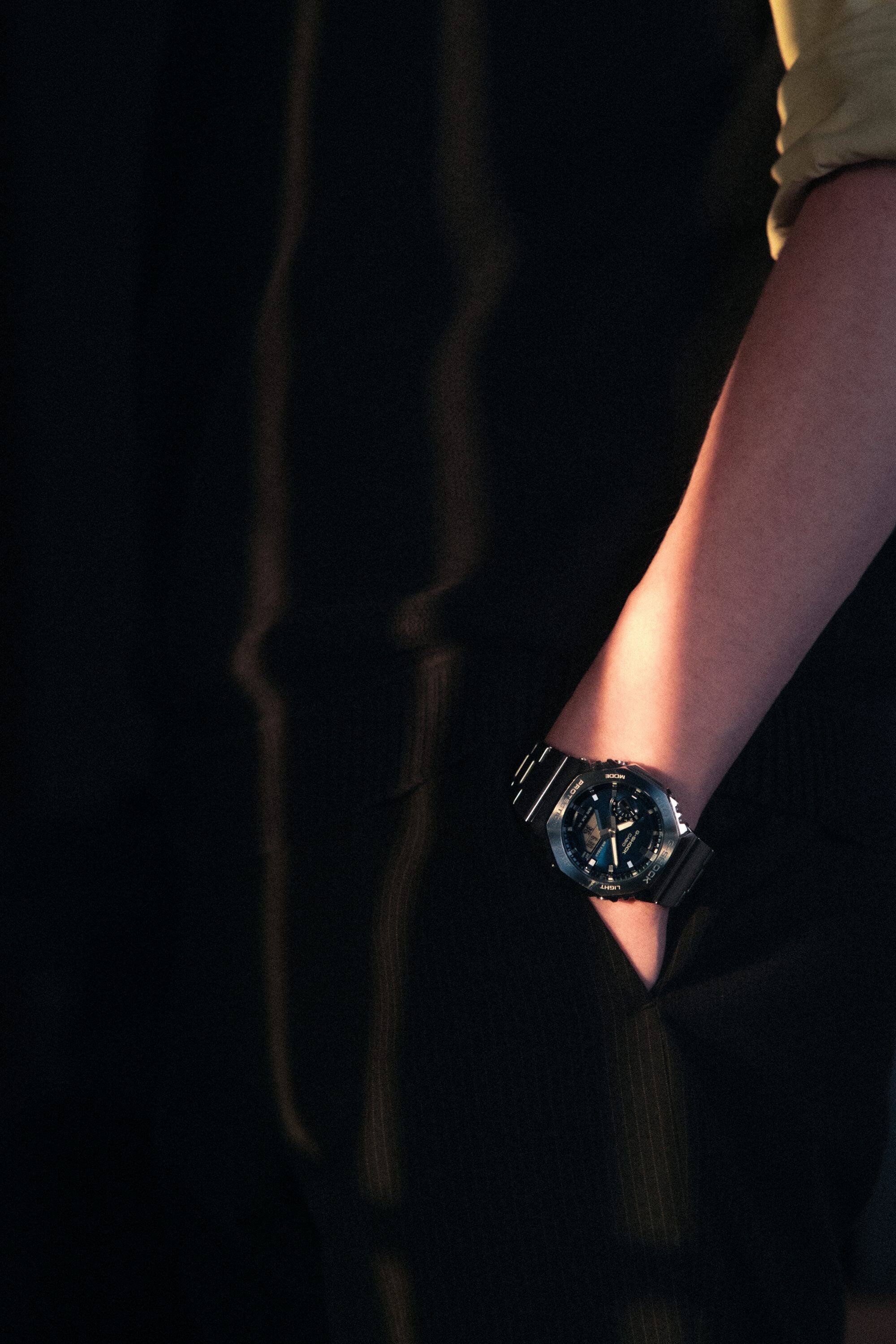 A man wearing a G-SHOCK GM-2110D-2B watch on his wrist.