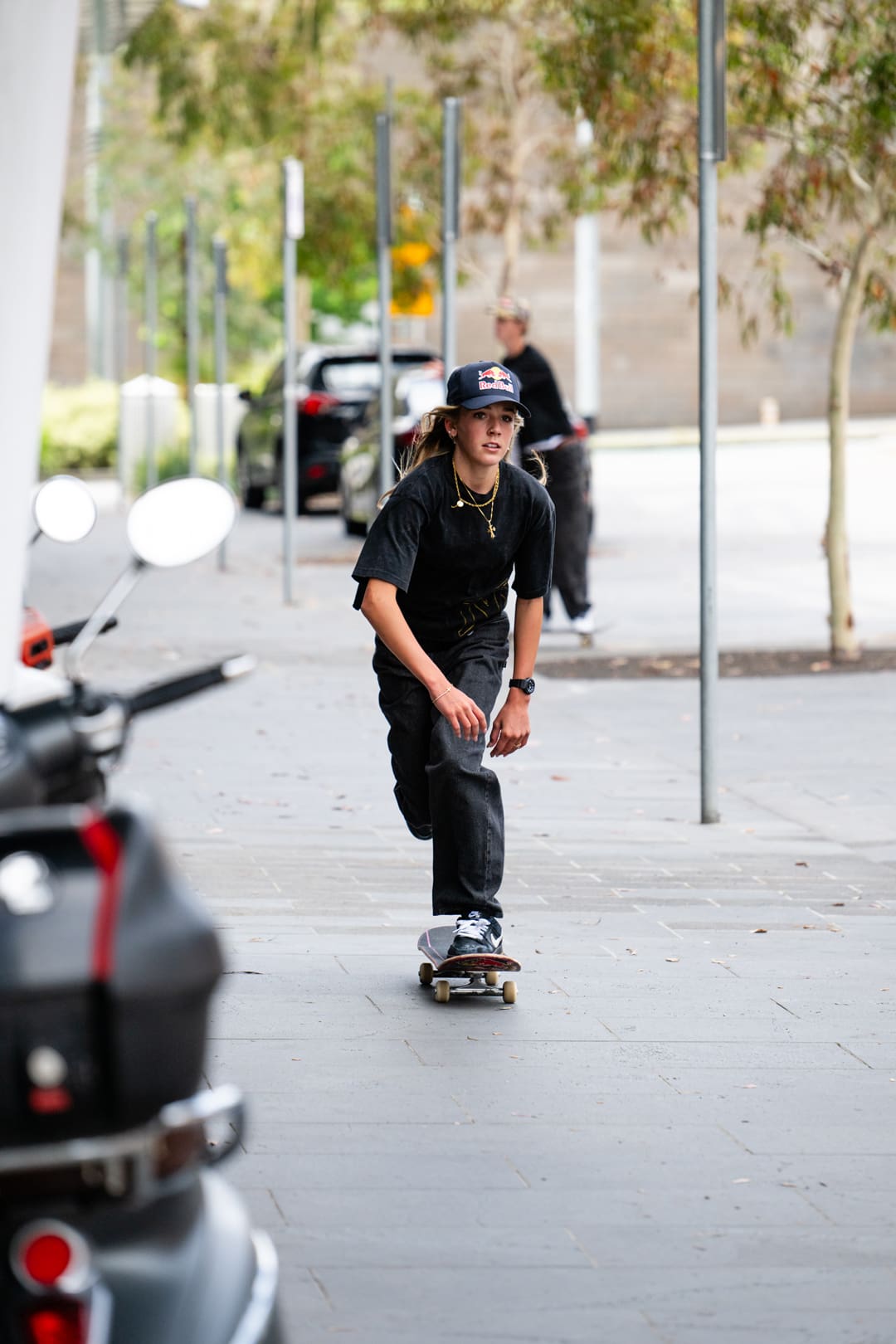 Rubi Rose lying beside large brown G-SHOCK.