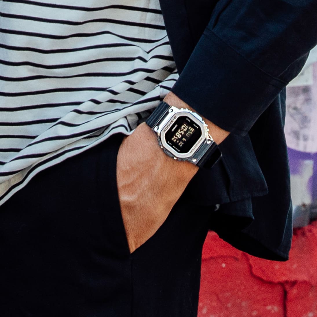 Una persona che indossa l'orologio metalcase GM-5600 con cinturino in resina nera al polso.