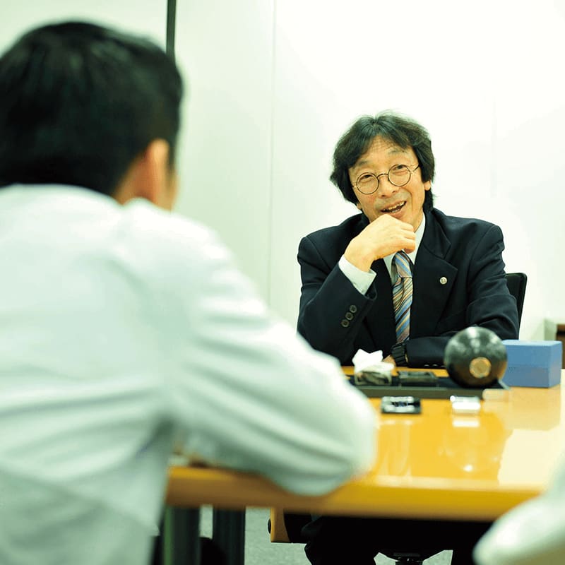Kikuo Ibe at meeting table