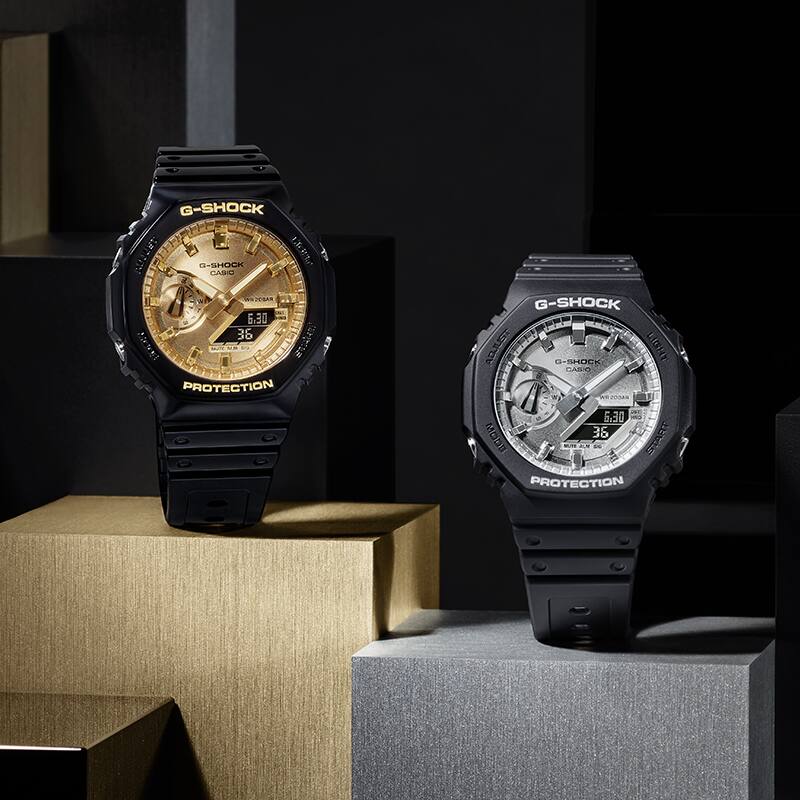 G-SHOCK GA-2100GB Gold colored watch face paired with glossy black and GA-2100SB Silver colored watch face paired with matte black