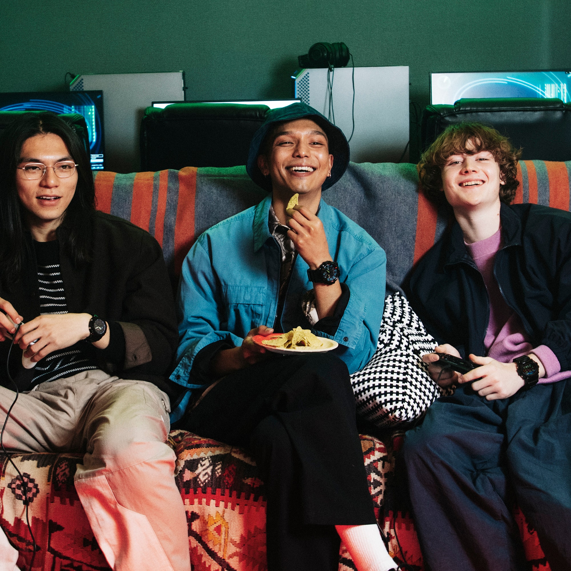 Three friends on a couch wearing G-SHOCK RGB Gamer watches
