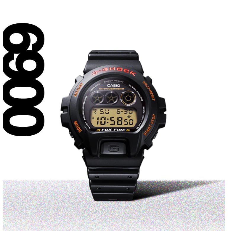 Het ronde digitale horloge G-Shock 6900 met grote kast, zwarte harsband en rode details