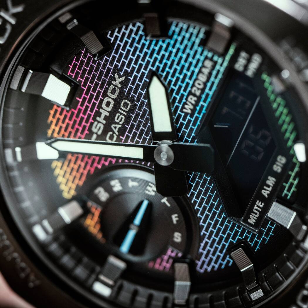 Close-up van de wijzerplaat van het GM-2100BRW-1AER horloge met een regenboogkleurige wijzerplaat