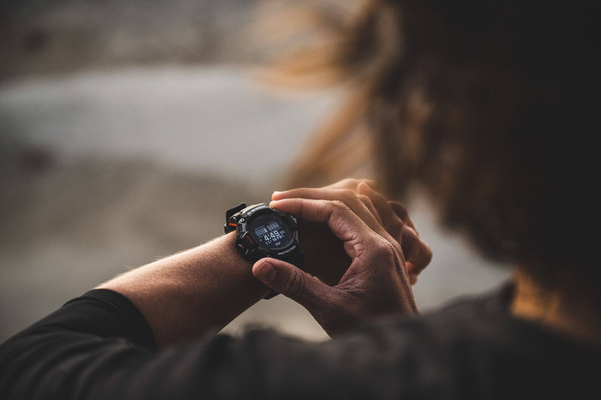 Man wearing GBDH2000-1A operating the watch before running.