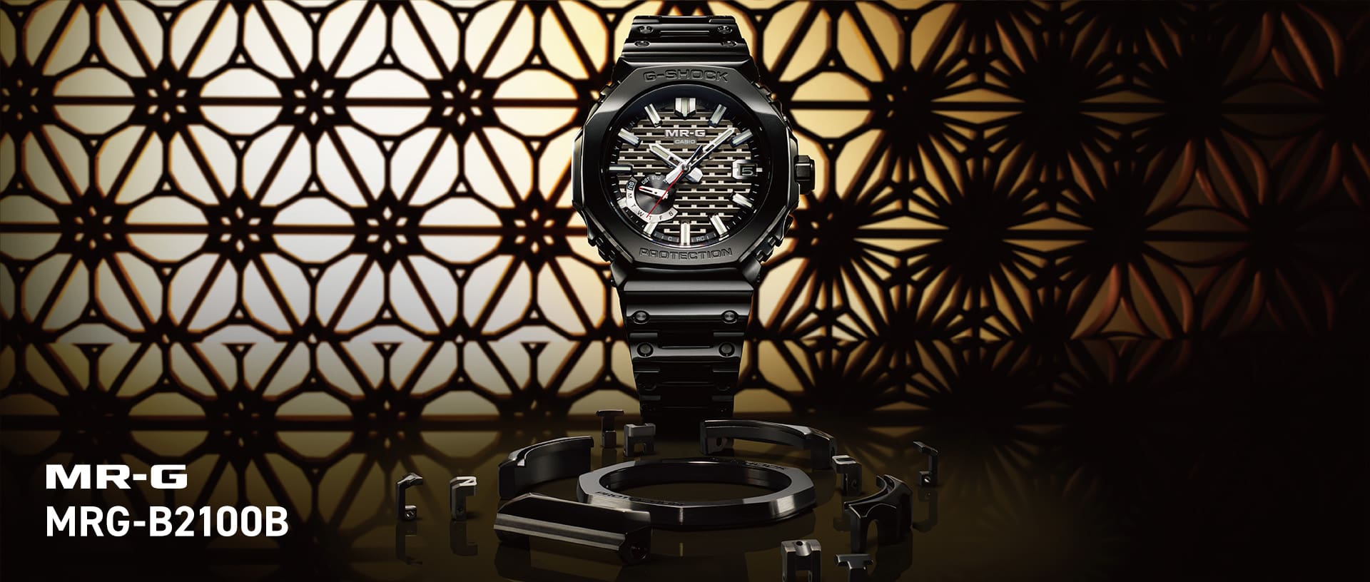 Relógio de pulso G-SHOCK MRG-B2100B com bracelete preta, caixa octogonal preta e detalhes prateados no mostrador.