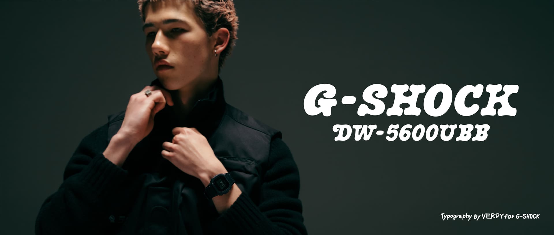 Portrait of person adjusting jacket wearing G-SHOCK DW-5600UB in dark setting.