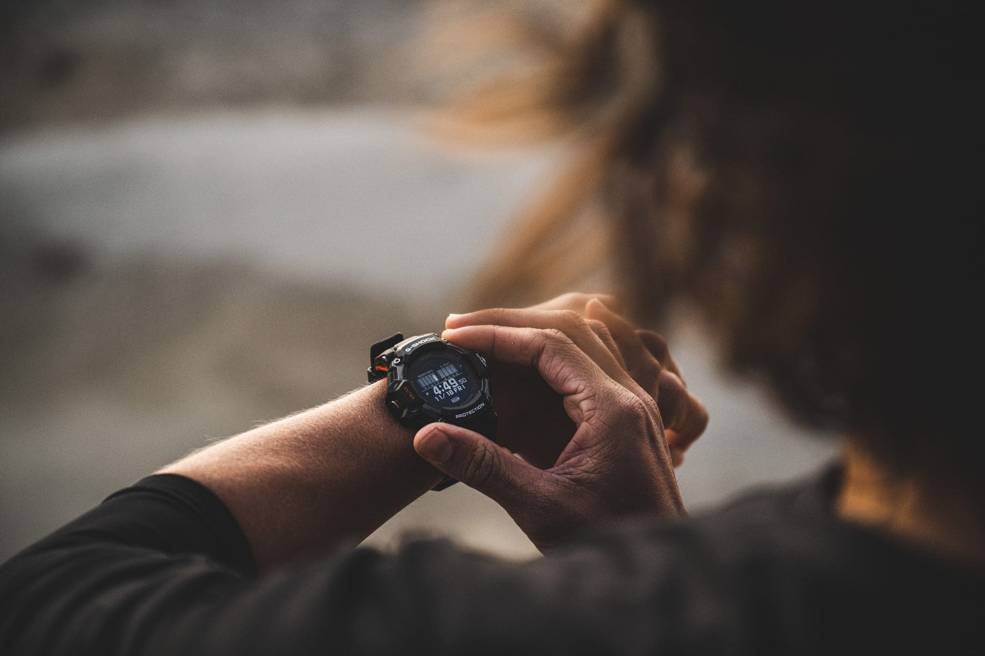 Man wearing GBD-H2000-1A operating the watch before running.