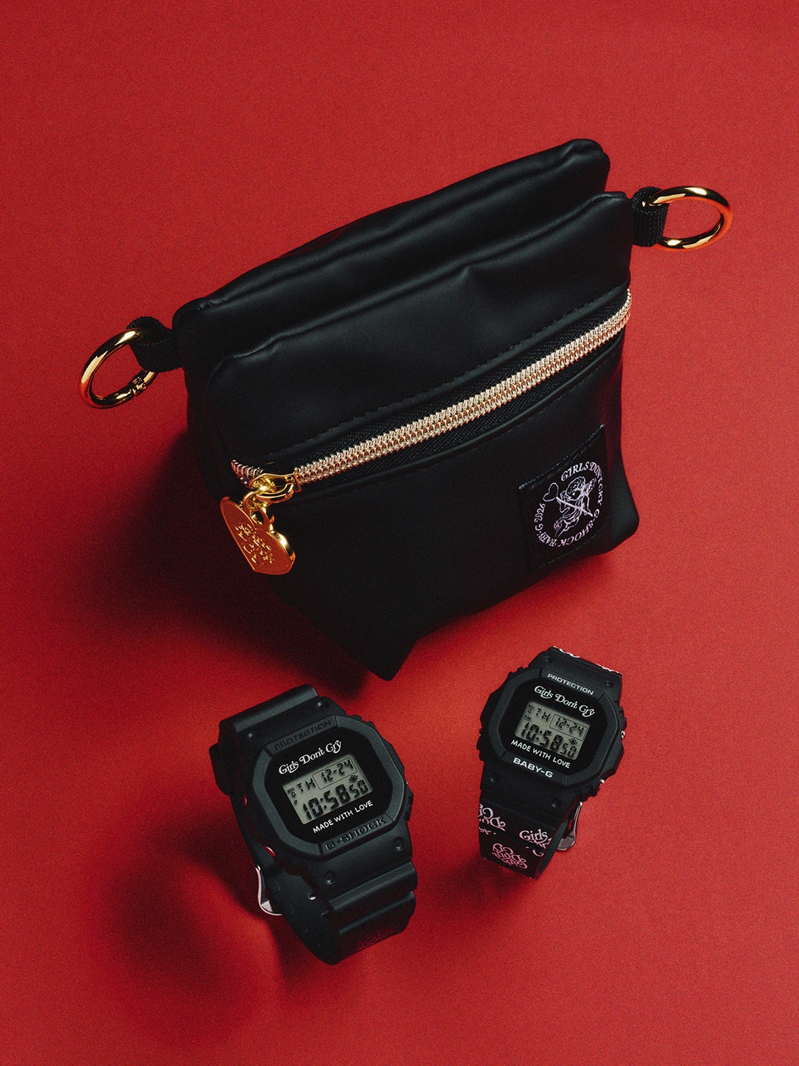 A photo of a black Girls Don't Cry pouch displayed with two black G-SHOCK digital watches.