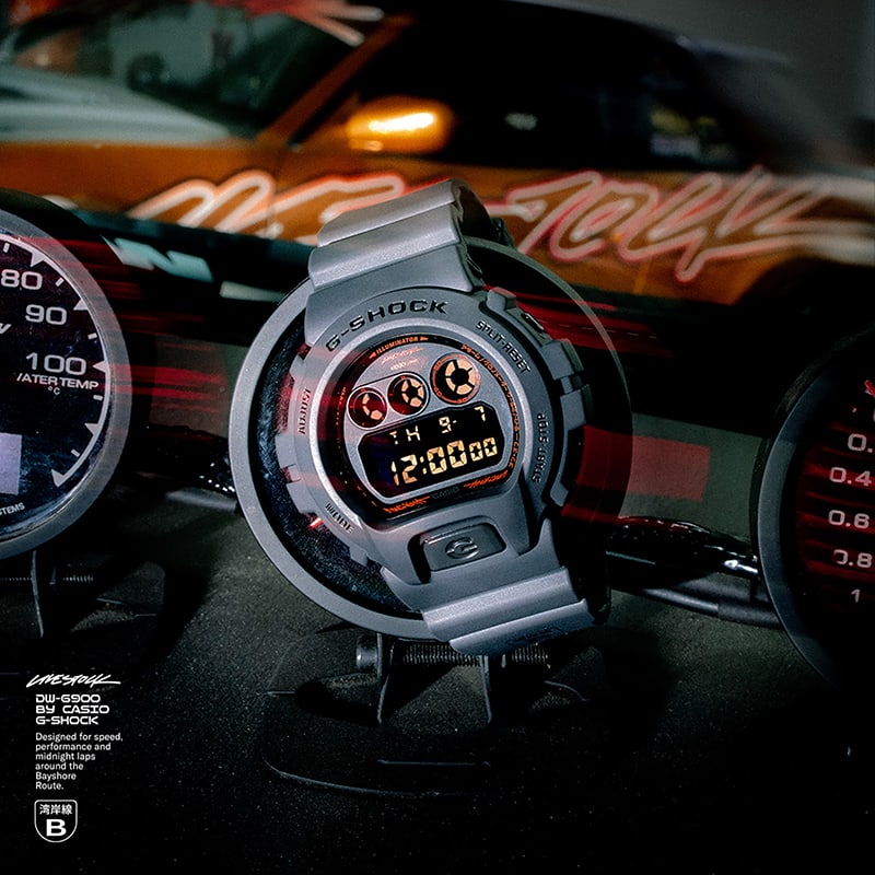 Livestock x G-SHOCK DW6900LVS238 watch resting on a street race car gauge cluster