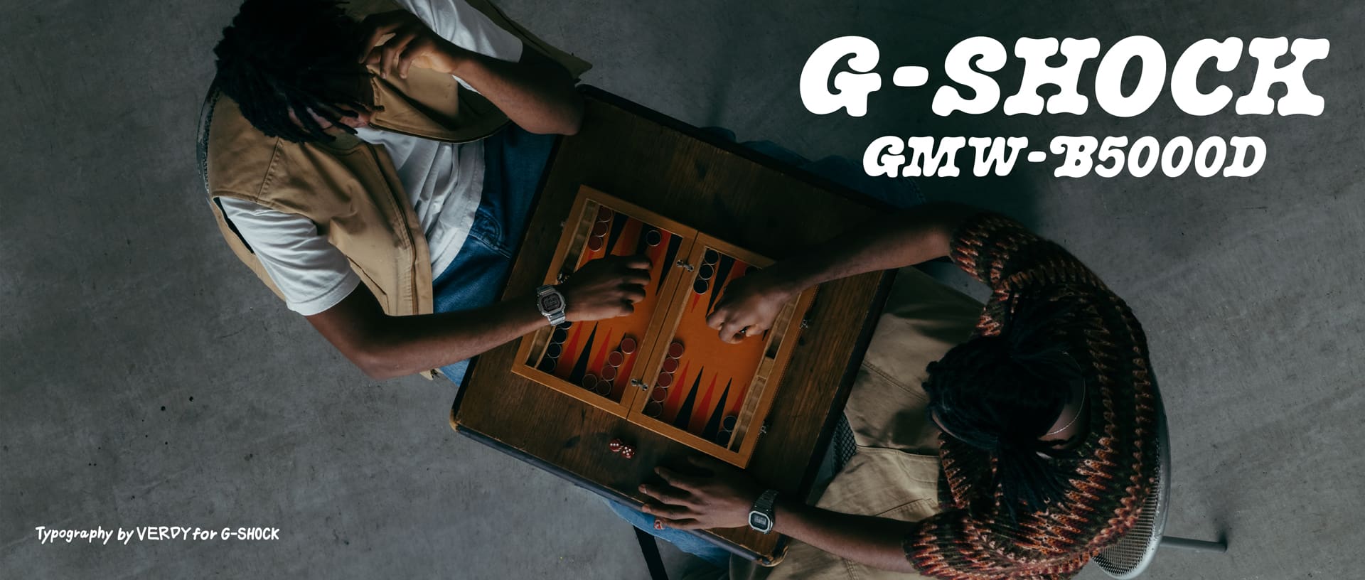 Top view of person playing board game wearing G-SHOCK GM-5600D at home.