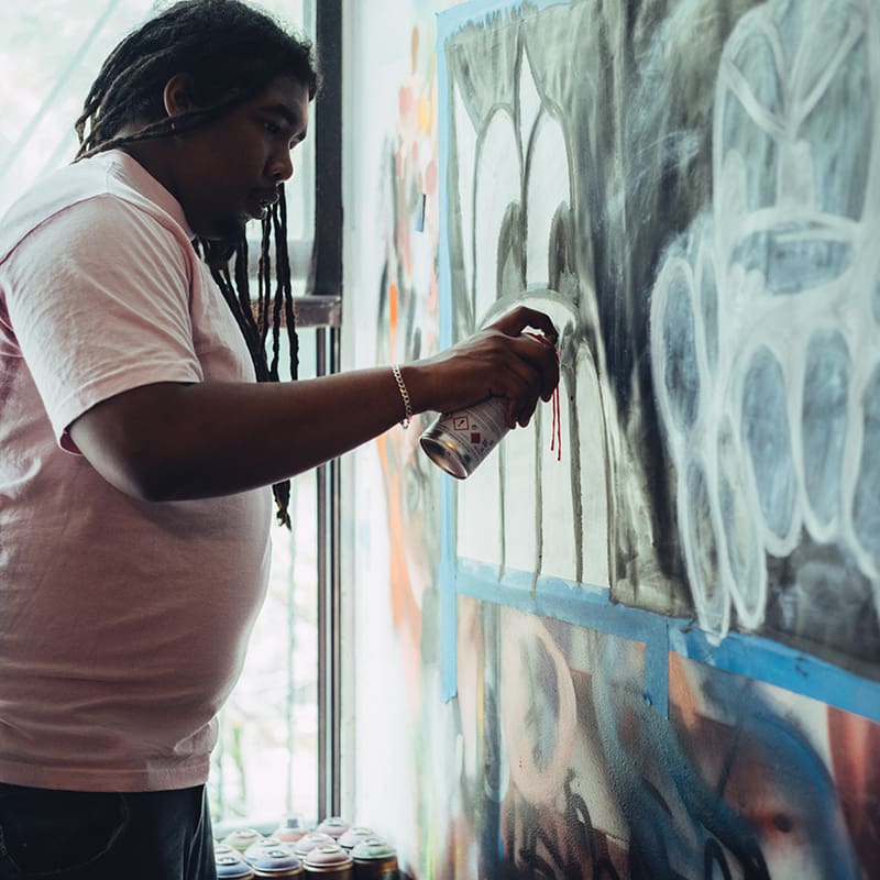 Amani Heywood working on his art