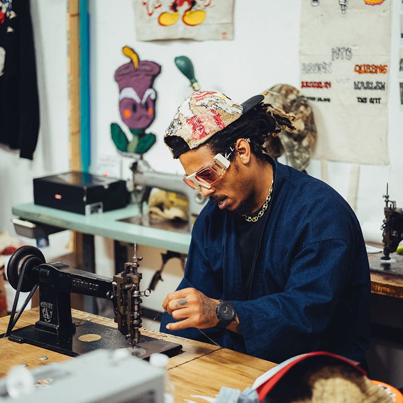 Racks Hogan working with thread and sewing machine