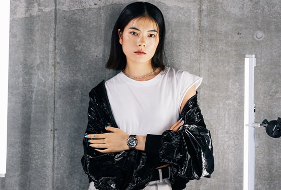 Woman wearing a black jacket and white shirt with a G-SHOCK GMS110 on her wrist