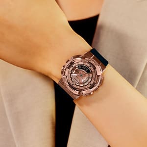 G-SHOCK GMS110 Rose gold colored metal covered analog digital watch on woman's wrist