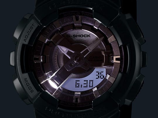 LED light illuminating the GMS110 analog digital watch face in the dark