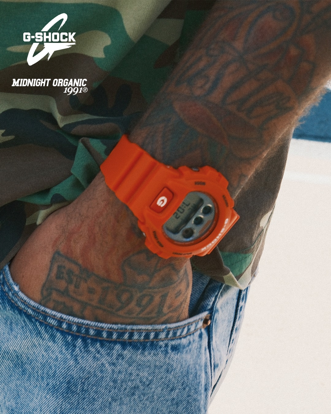 Man leaning on a care wearing G-SHOCK x TOYO TIRES DW5600TT25-1 