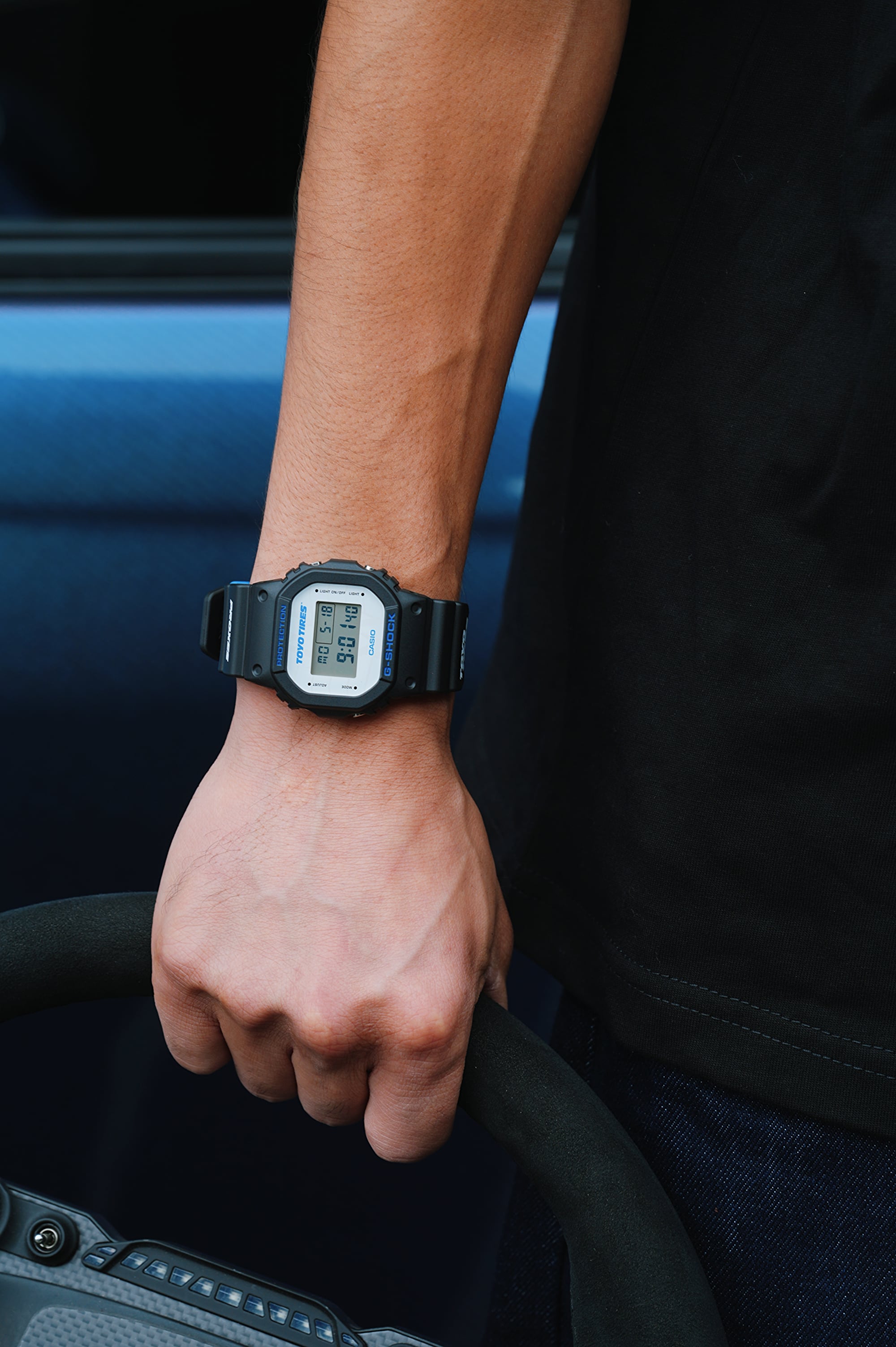 close up of G-SHOCK x TOYO TIRES DW5600TT25-1 on man's wrist