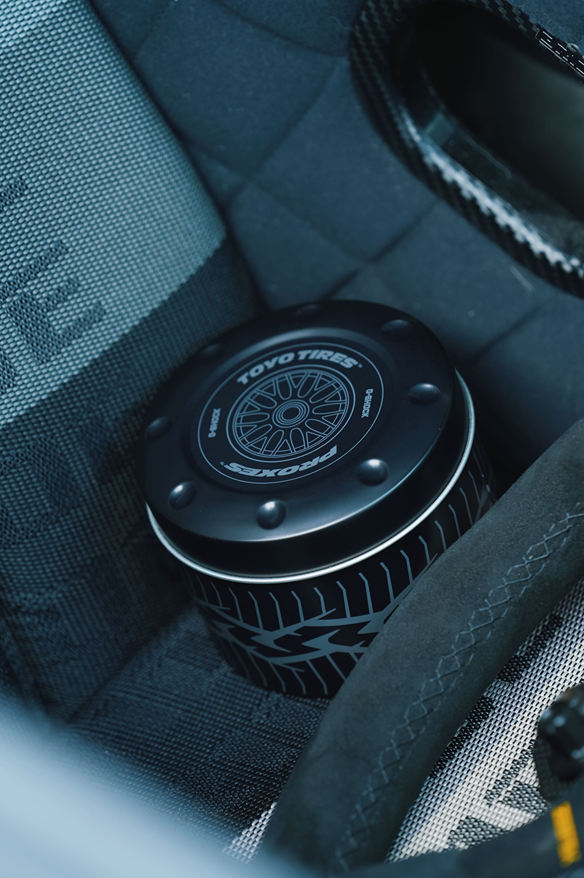 close up shot of G-SHOCK x TOYO TIRES DW5600TT25-1 special tin packaging