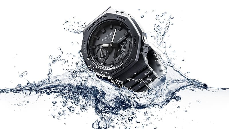 G-SHOCK GA2100-1A1 mil-spec watch hitting a water surface denoting toughness and style.