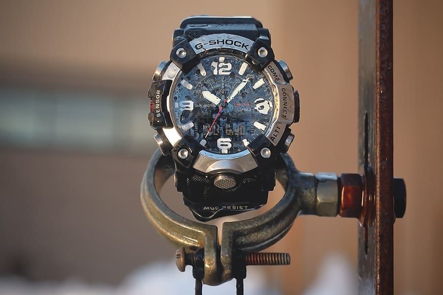 Close up of G-SHOCK GGB100XM-1A mil-spec watch undergoing the MIL-STD-810 blowing rain test denoting toughness.