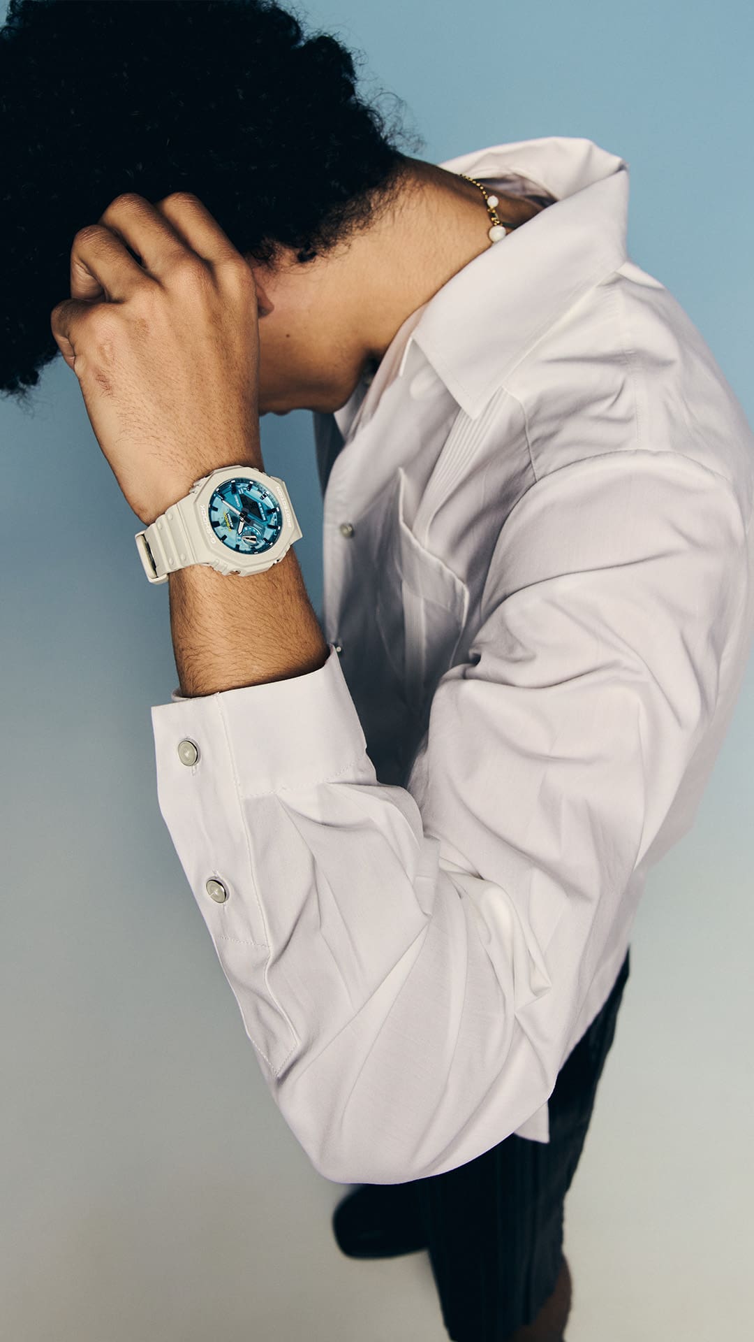 Medium shot of the G-SHOCK GA2100AS-5A blue-dial watch on a man’s wrist denoting style