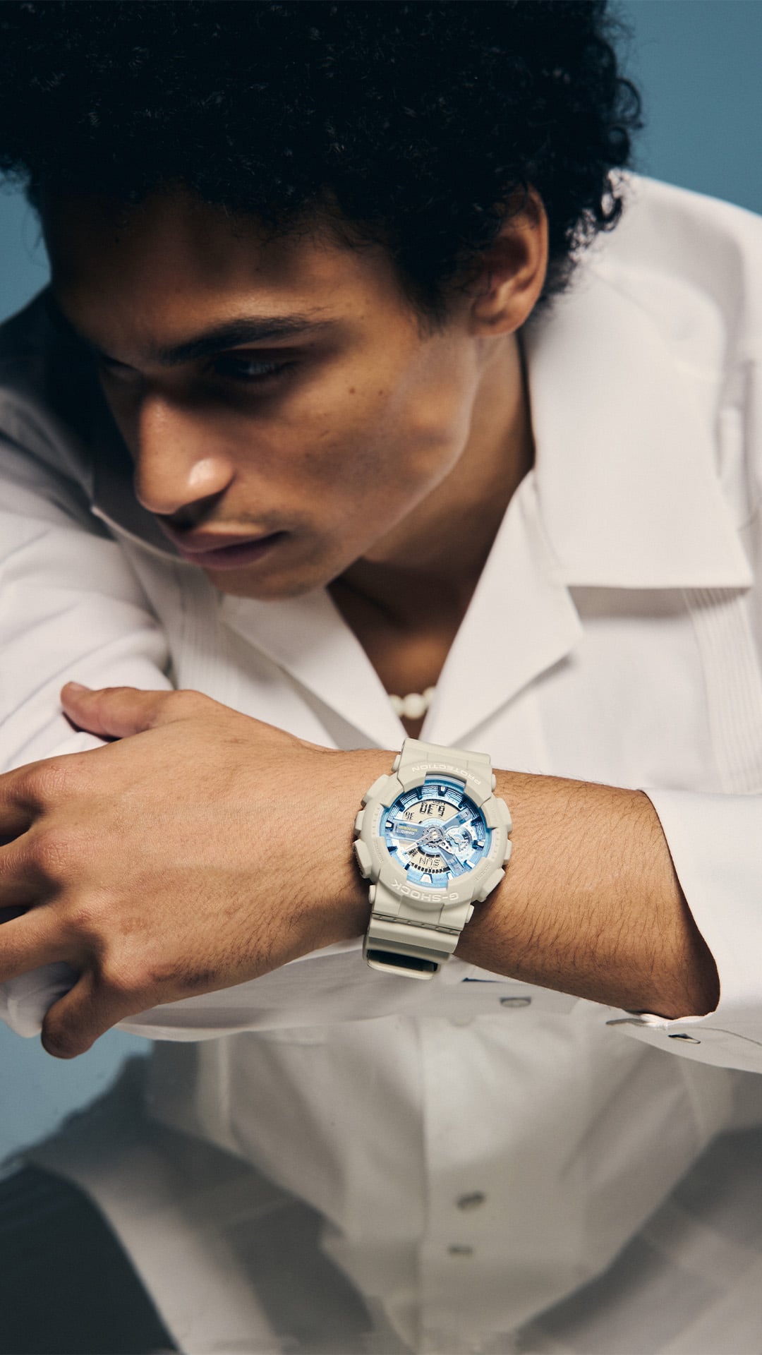 Medium shot of the G-SHOCK GA110AS-5A blue-dial watch on a man’s wrist denoting style