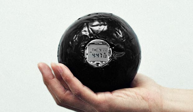 Rubber ball with watch face denoting the experimental prototype for the G-SHOCK DW5000C watch.