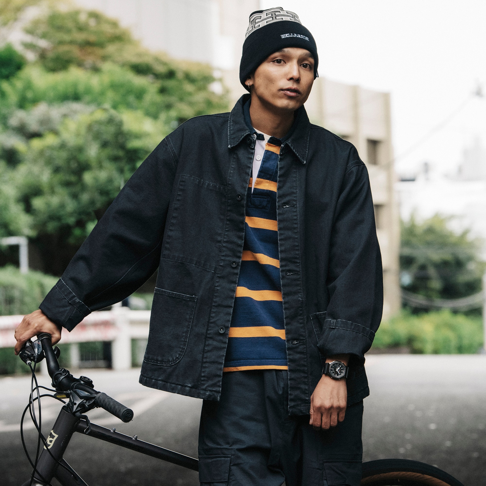 Man wearing a G-SHOCK GM2100CB-1A Metal covered analog digital utility watch with cloth band while leaning against a bicycle Man wearing a G-SHOCK GM2100CB-1A Metal covered analog digital utility watch with cloth band while leaning against a bicycle