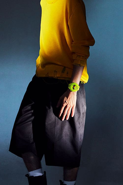 Fashion Photo, Model wearing G-SHOCK GA-V01-9A green analog digital watch with yellow shirt and baggy black shorts