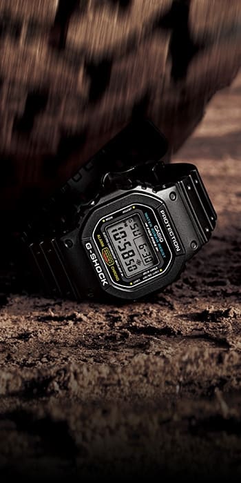 G-SHOCK DW5600 watch being run over by a truck tire to denote toughness.