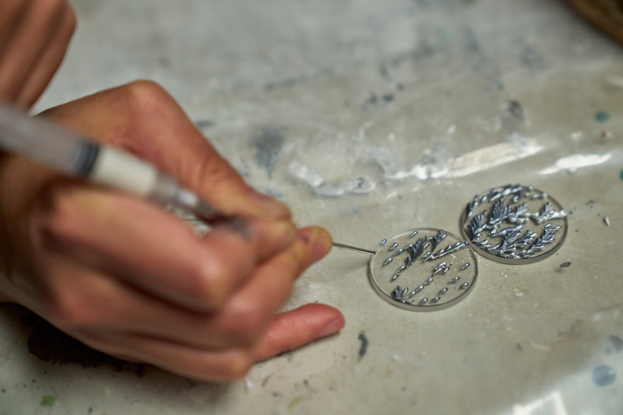 Applying paint with a syringe to create an organic appearance
