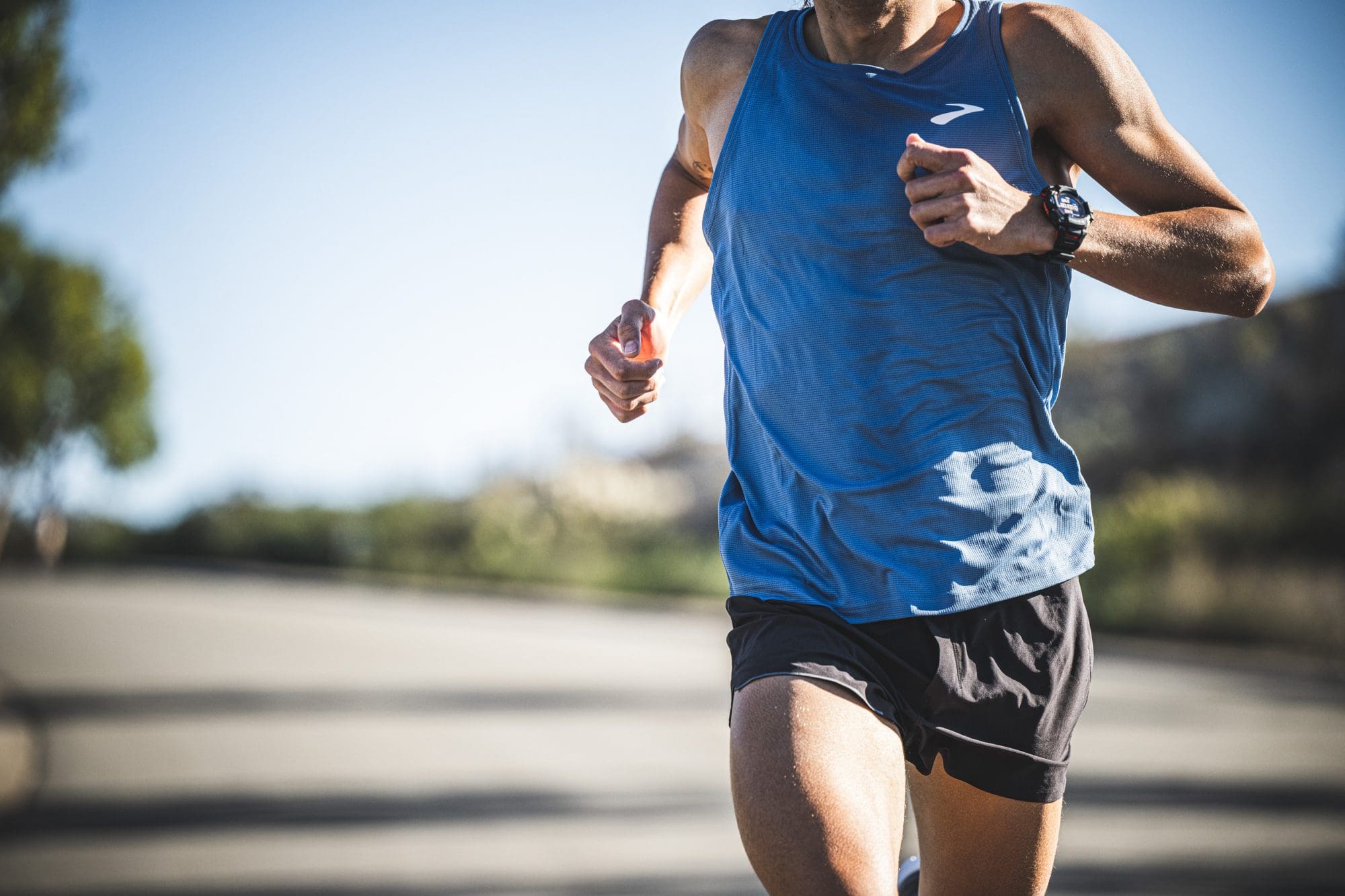 man wearing black G-SHOCK MOVE GBD-H2000-1A running on a road man wearing black G-SHOCK MOVE GBD-H2000-1A running on a road