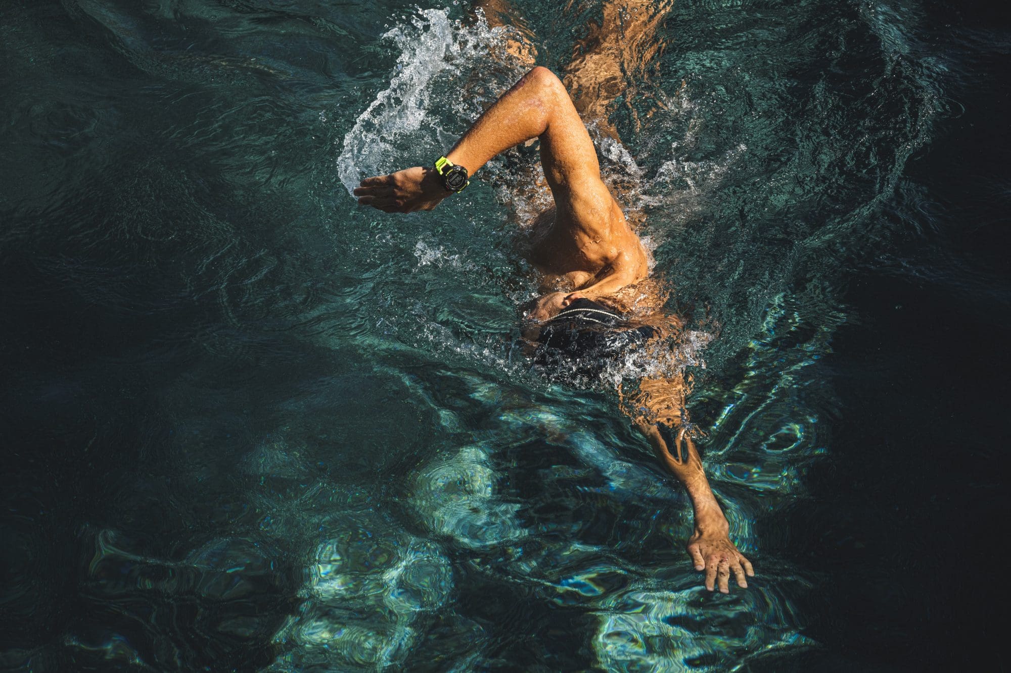 man wearing black and yellow G-SHOCK MOVE GBD-H2000-1A9 swimming in pool man wearing black and yellow G-SHOCK MOVE GBD-H2000-1A9 swimming in pool