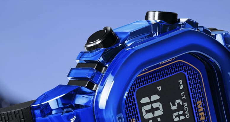 Macro view of the blue bezel, controls and upper case detailing.