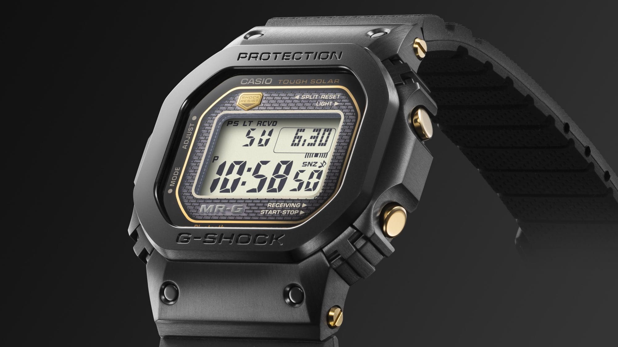 Leicht seitliche Ansicht der schwarzen Casio G-Shock MRG-B5000R-1 Digitaluhr mit Blick auf die goldfarbenen Bedienknöpfe und Schrauben