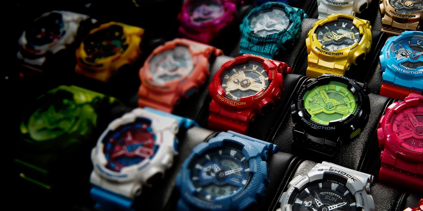 A display case with many different, colourful Casio G-Shock GA-110 wristwatches