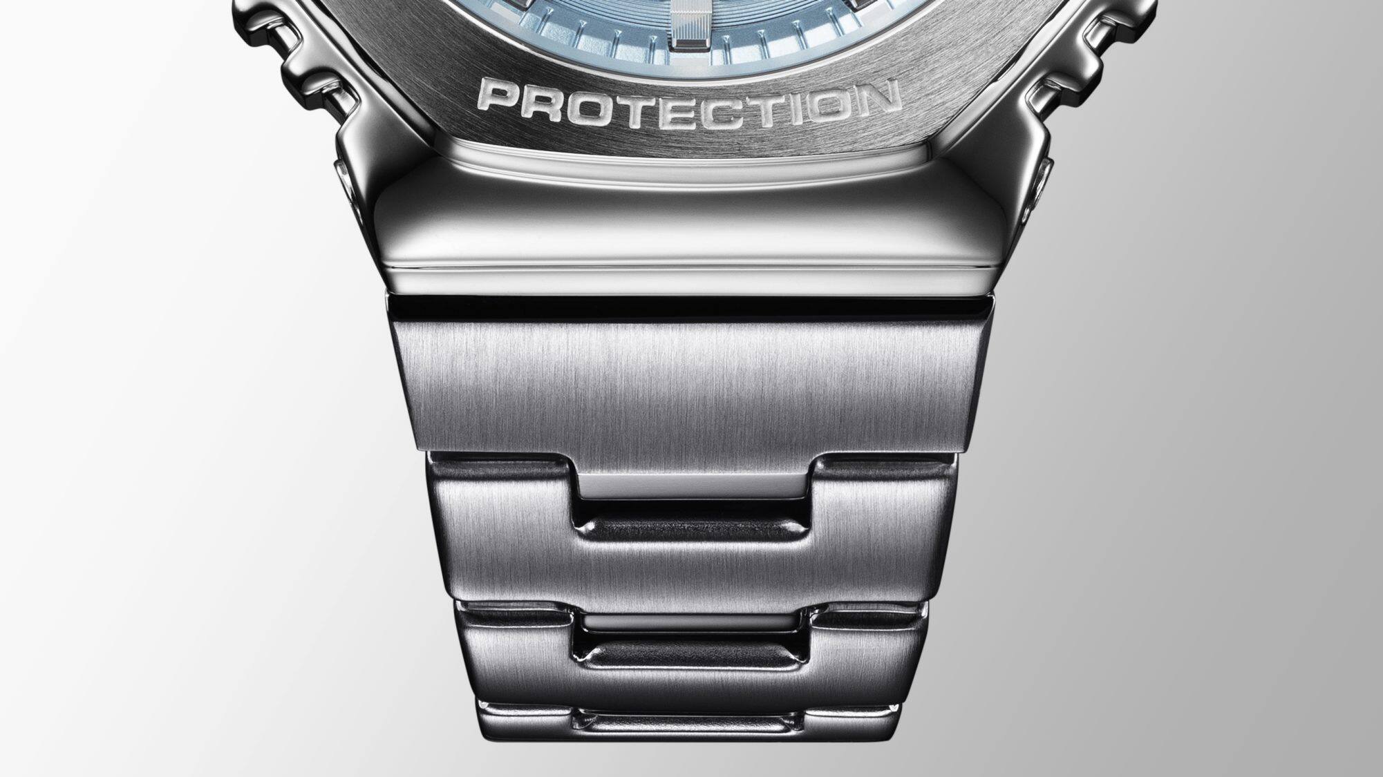 Close-up of the transition from the metal bracelet to the metal bezel of a Casio G-Shock GM-2110D wristwatch