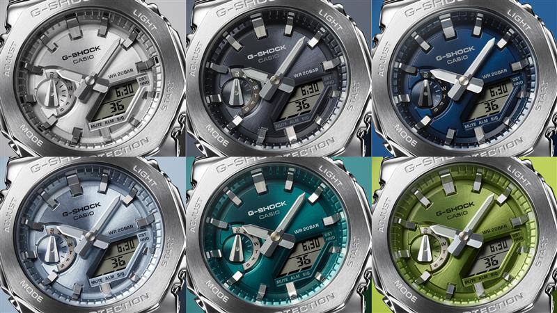 Six colour variants of the Casio G-Shock GM-2110D series next to each other: the GM-2110D-7A wristwatch with a silver-coloured dial, one with a grey-blue dial next to the GM-S2110 with a dark blue dial, a light blue dial, the watch with a turqoise dial and the metal watch with a green dial.