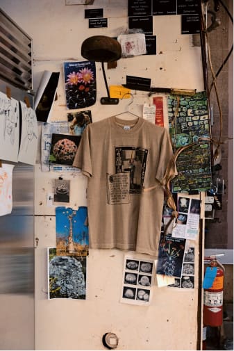 A wall in The Cactus Store with a shirt and multiple photos on it.