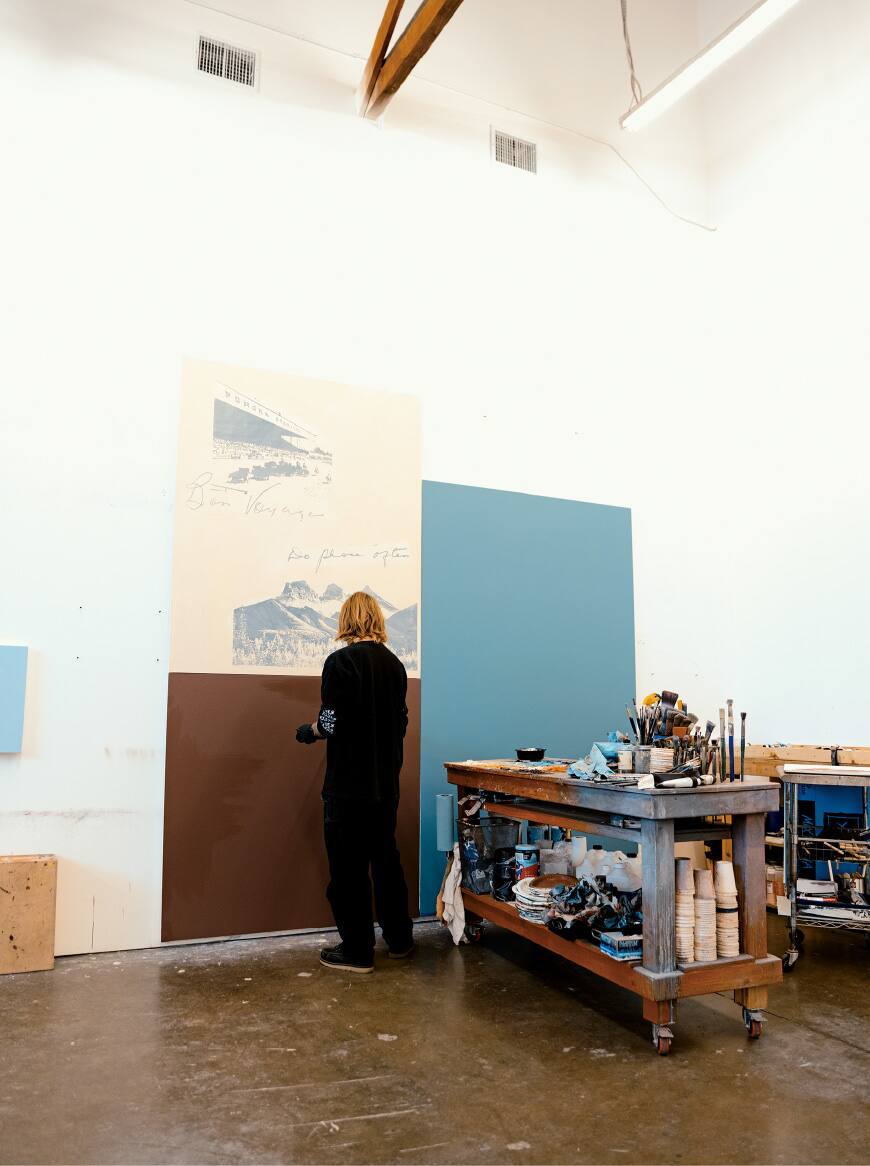 A photo of McCormick creating artwork in the studio.