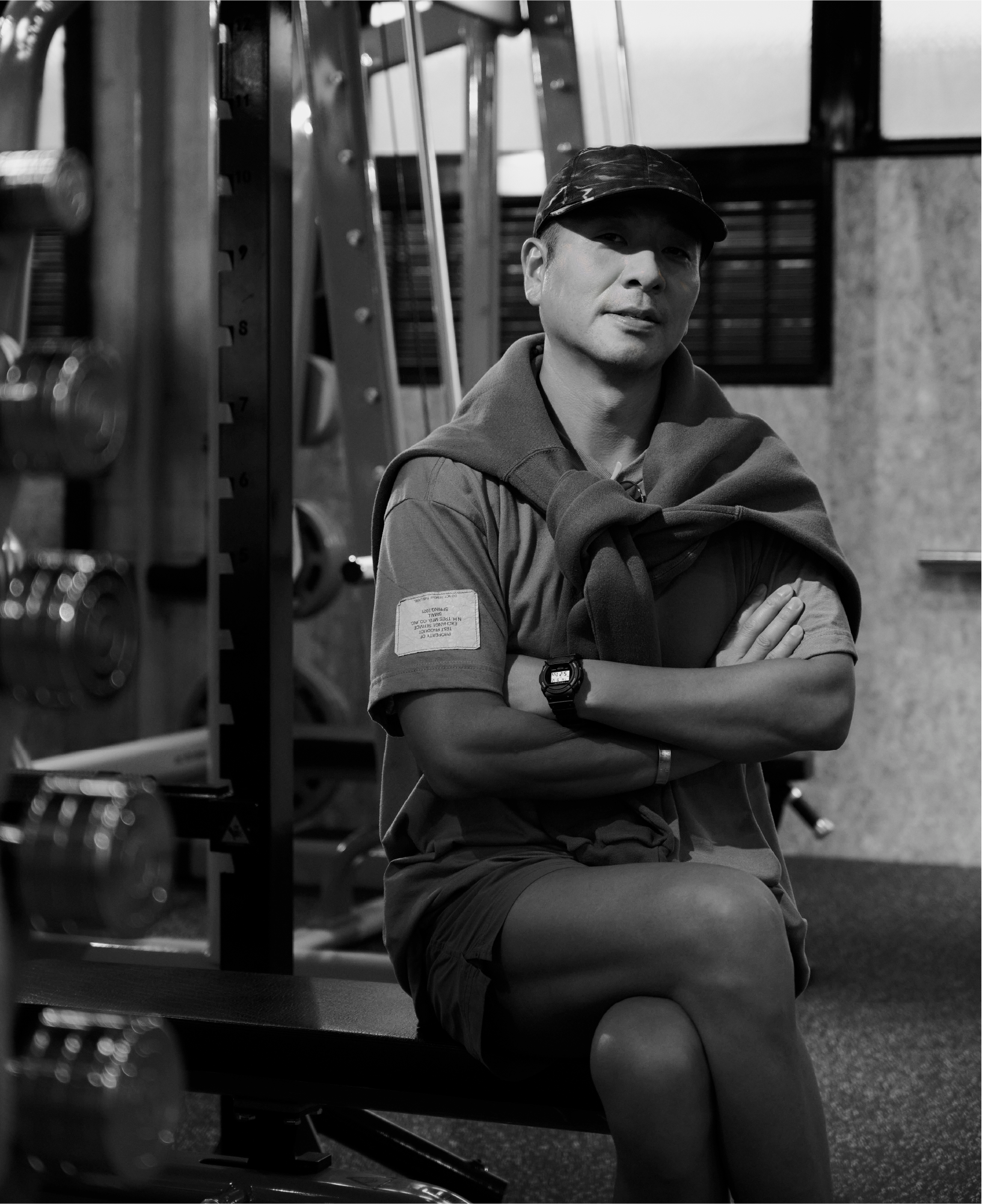 Daisuke Obana poses with his arms crossed on a chair, wearing a G-SHOCK watch.